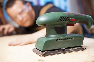 Cropped hand of person using sewing machine