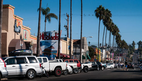 Cars on road against sky in city