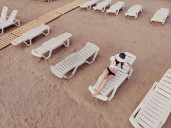 High angle view of chairs on table at beach