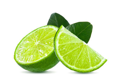 Close-up of green fruit against white background