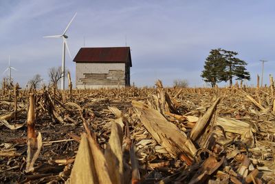 Traditional windmill on field against sky