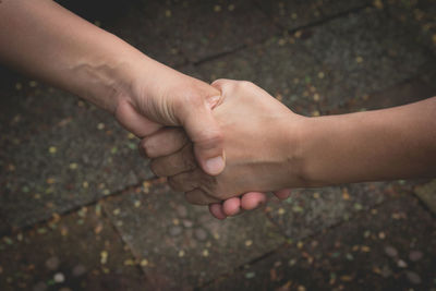 Close-up of hands touching finger