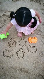 High angle view of girl playing on beach