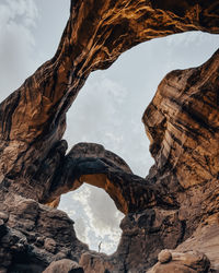 Low angle view of rock formation against sky