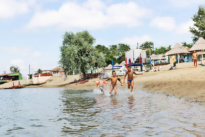 People on beach against sky