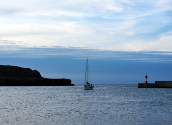 Sailboats sailing on sea against sky