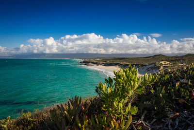 View of beach against cloudy sky