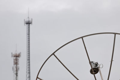 Low angle view of communications tower against sky