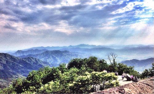 Scenic view of mountains against cloudy sky