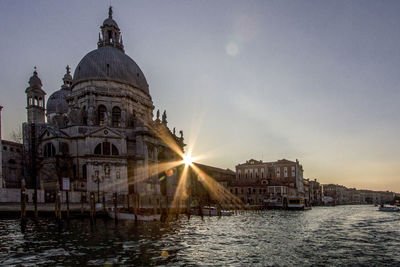 Low angle view of saint mark basilica by river against sky