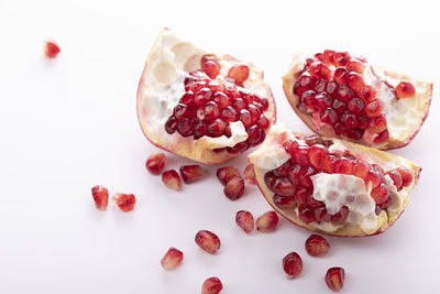 High angle view of strawberries in plate against white background