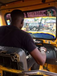 Rear view of man working in bus