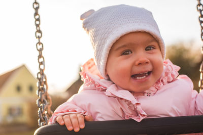 Portrait of happy girl on swing