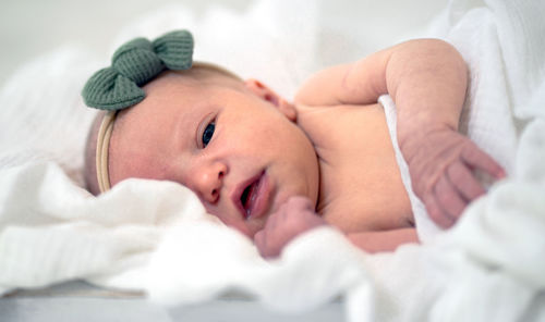 High angle view of baby boy sleeping on bed at home