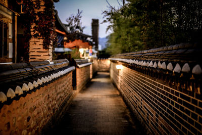 Illuminated walkway against sky