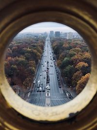 Highway in city seen through hole 