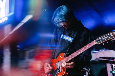 Man playing guitar at music concert