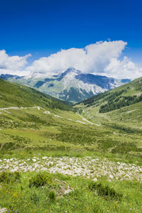 Scenic view of mountains against blue sky