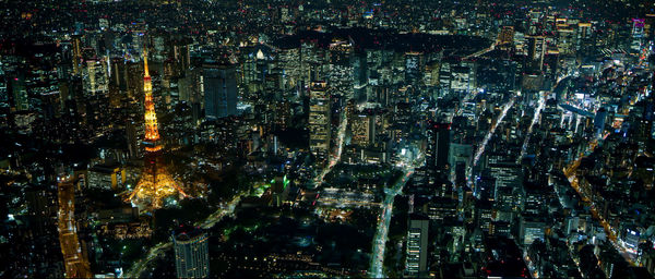 High angle view of illuminated modern buildings in city at night