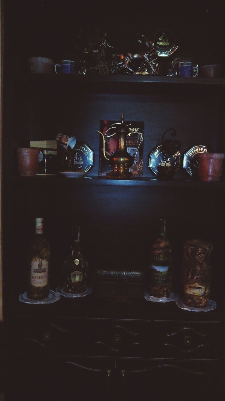 indoors, still life, table, close-up, glass - material, illuminated, no people, home interior, bottle, drink, jar, transparent, candle, shelf, night, food and drink, reflection, selective focus, old-fashioned, retro styled