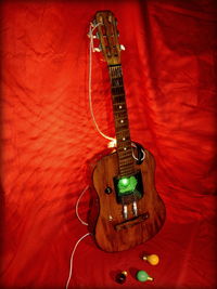 High angle view of illuminated guitar against wall