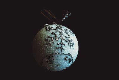 Close-up of electric lamp against black background