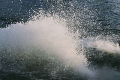 Close-up of water splashing against sky