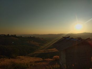 Scenic view of field against clear sky during sunset