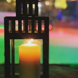 Close-up of lit candles on table