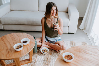 Young woman drinking glasses on table