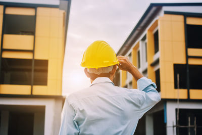 Man working at construction site against building