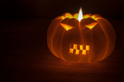 Close-up of illuminated pumpkin against black background