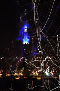 Close-up of illuminated lights against sky at night