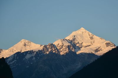 Scenic view of snowcapped mountains against clear sky