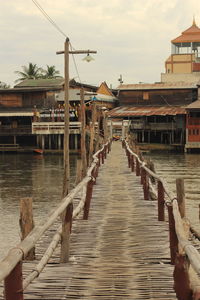 Pier amidst buildings against sky