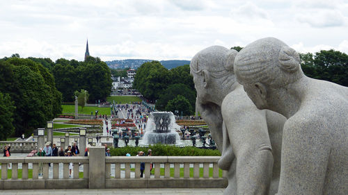 Statue by trees against sky