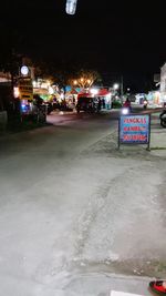 Illuminated city street at night