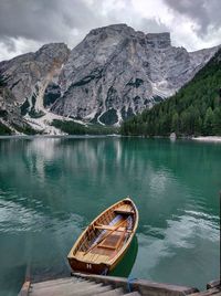 Scenic view of lake by mountains against sky