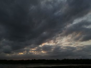 Scenic view of dramatic sky over field