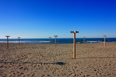 Scenic view of beach against clear blue sky