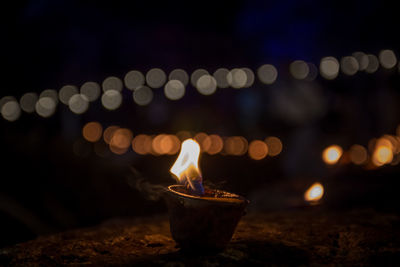 Close-up of lit candles in the dark