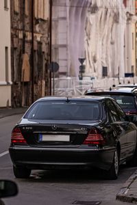 Cars parked on street by buildings in city