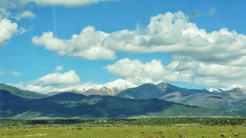 Scenic view of mountains against cloudy sky