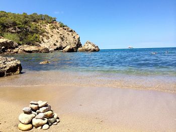 Scenic view of beach against clear sky