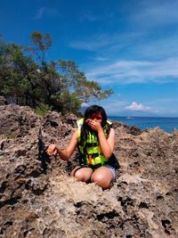 Woman sitting on rock