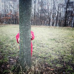 Midsection of man with flower tree in forest