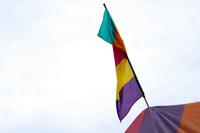 Low angle view of flag flags against sky