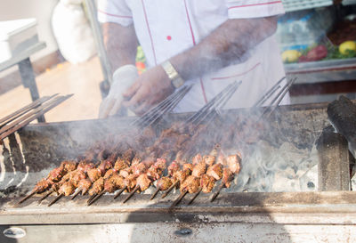 Man preparing food on barbecue grill