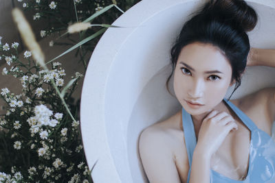 Portrait of beautiful woman relaxing in bathtub