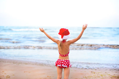 Rear view of boy on beach